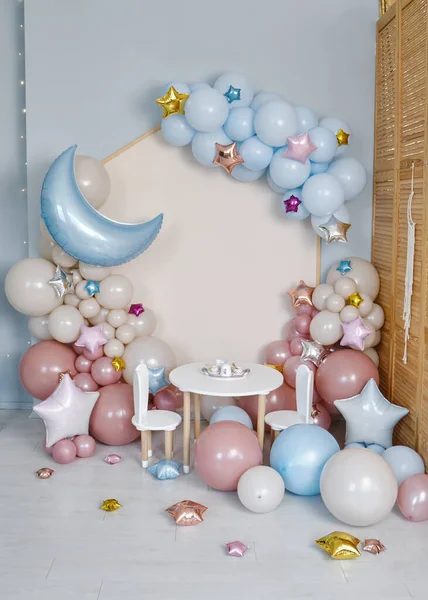 Children\'s photo zone with a lot of balloons. Decorations for boys and Girls Birthday party. Concept of children\'s birthday party. Cream-colored and pink balls.