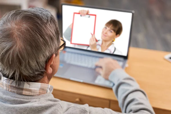 Close up of modern elderly man sit at home having online consultation with doctor on computer. Sick senior male talk on video call consulting with female nurse using laptop, healthcare concept