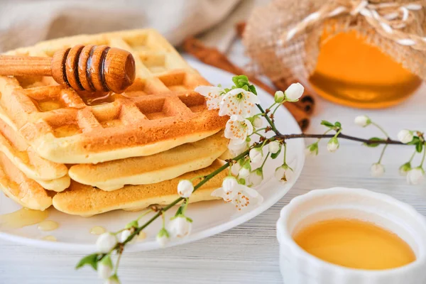 新鮮なベルギーのワッフルに蜂蜜を注ぐ 有機健康的な春の朝食ミネラルやビタミンが豊富です 朝食にエコフード 桜と一緒に甘い菓子の流行 — ストック写真
