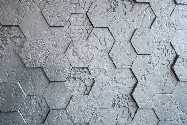 Background made of grey hexagonal gypsum tiles, textured, mosaic. Modern renovation.