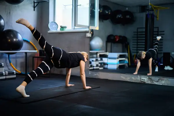 stock image Young attractive sportive woman wearing activewear doing exercises at GYM, working out indoors, healthy active lifestyle concept