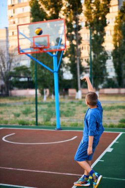 Oyun sahasında basketbol oynayan neşeli, genç bir çocuk. Çocuk, şehir binalarının arka planına karşı Red Court 'ta sahne alıyor. Aktif yaşam tarzı, eğitim, profesyonel spor