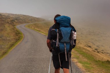 Pilgrims from behind along the Camino de Santiago. Path of the way of St James in the French Pyrenees