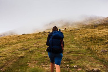 Pilgrim from behind along the Camino de Santiago. Path of the way of St James in the French Pyrenees