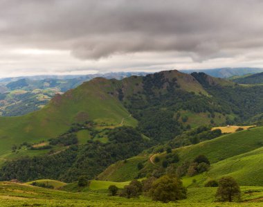 Mountain landscape, green valley along the Way of Saint James in the French Pyrenees. Clouds floating over the tops of the mountains. Landscape on the trail of Napoleon from France to Spain. High quality photo
