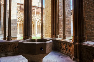 The Holy Water stoup in the ornate gothic cloister arcade arches of the Pamplona Cathedral de Santa Maria la Real, 15th Century Gothic Cathedral