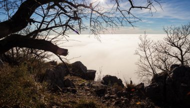 Clouds drift amid rocky cliffs in the Trieste landscape. Italy