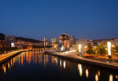 Bilbao, İspanya - 2 Ağustos 2022: Amerikan mimar Frank Gehry tarafından tasarlanan ve Ekim 1997 'de hizmete giren modern ve çağdaş sanat eseri Guggenheim Müzesi' nin günbatımı.