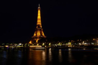 Paris, France - July, 13: Eiffel Tower brightly illuminated at dusk in Paris. It's the most visited monument of France on 13 July, 2022