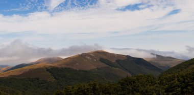 Mountain landscape, green valley along the Way of Saint James in the French Pyrenees. Clouds floating over the tops of the mountains. Landscape on the trail of Napoleon from France to Spain. High quality photo