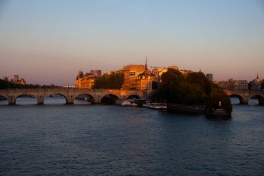 View of the River Seine and the famous bridge called Pont Neuf at sunny summer sunset, Paris