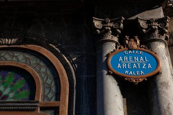 Ornate gold and blue street name plaque on the corner of Arenal Areatza in Bilbao