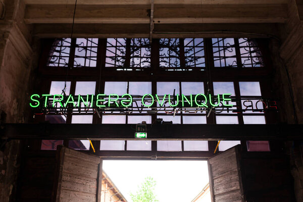 Venice, Italy - April 18, 2024: Installation by Claire Fontaine titled Foreigners Everywhere/Stranieri Ovunque at the Entrance of the Arsenale for the 60th International Art exhibition of Venice biennale