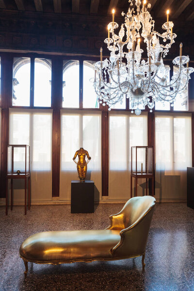 Venice, Italy - April 19, 2024: Chaise Longue and ancient chandelier. Istituto Veneto di Scienze, Lettere ed Arti, Venice