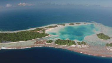 Aerial drone view of Rangiroa atoll showing the turquoise lagoon, coral reefs, and forested motus, typical of the tuamotu archipelago in French Polynesia. Remote wild nature exotic travel background clipart