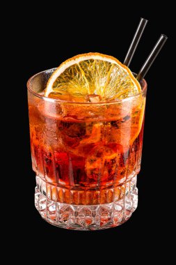 Spritz aperitif aperol cocktail with orange slices and ice cubes isolated on black background 