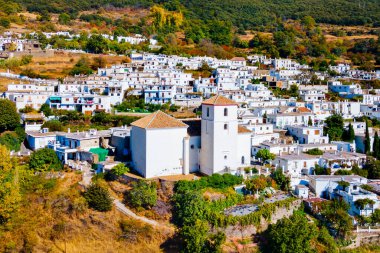 Our Lady of the Rosary Church aerial panoramic view in Bubion. Bubion is a village in the Alpujarras area in the province of Granada in Andalusia, Spain. clipart