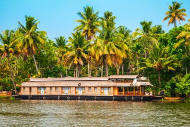 A houseboat sailing in Alappuzha backwaters in Kerala state in India clipart