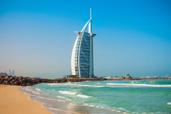 stock image DUBAI, UAE - FEBRUARY 27, 2019: Burj Al Arab luxury hotel and Jumeirah public beach in Dubai city in UAE