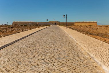 Sagres, Portugal: People walking through the Fortaleza de Sangres in the Algarve, Portugal in summer.
