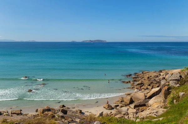 Galicia, Spain: People in Galicia beach in a summer day, Galicia. Spain