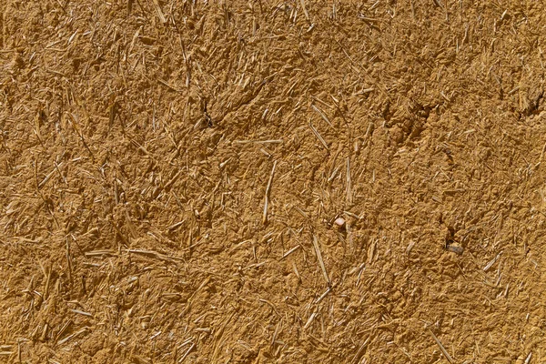 clay and straw material weathered wall of rural old country house close up. Galicia, Spain