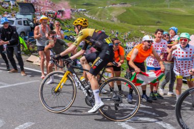 Col du Tourmalet, France: Jonas Vingegaard climbig the road to Col du Tourmalet in Pyerenees mountains during the stage 6 of Le Tour de France 2023. clipart