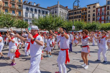 Pamplona, Spain: People celebrate San Fermin festival in traditional white abd red clothing with red necktie, Pamplona, Navarra, Spain.