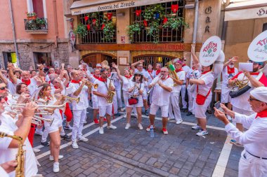 Pamplona, Spain: People celebrate San Fermin festival in traditional white abd red clothing with red necktie, Pamplona, Navarra, Spain.