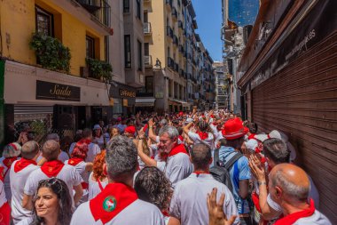 Pamplona, Spain: People celebrate San Fermin festival in traditional white abd red clothing with red necktie, Pamplona, Navarra, Spain.