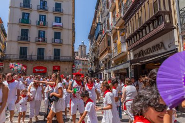 Pamplona, Spain: People celebrate San Fermin festival in traditional white abd red clothing with red necktie, Pamplona, Navarra, Spain.