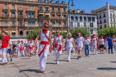 Pamplona, Spain: People celebrate San Fermin festival in traditional white abd red clothing with red necktie, Pamplona, Navarra, Spain.