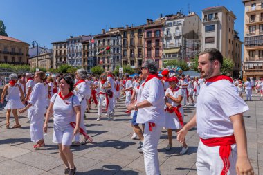Pamplona, Spain: People celebrate San Fermin festival in traditional white abd red clothing with red necktie, Pamplona, Navarra, Spain.