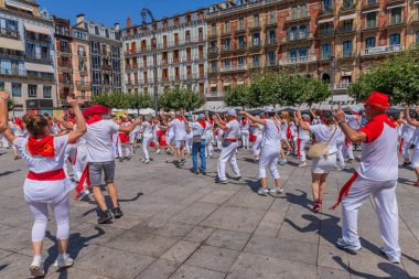Pamplona, Spain: People celebrate San Fermin festival in traditional white abd red clothing with red necktie, Pamplona, Navarra, Spain.