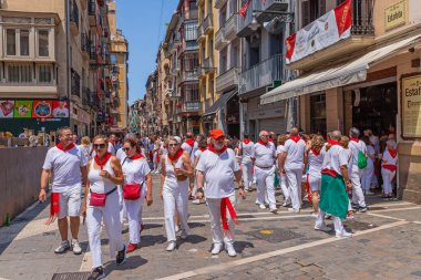 Pamplona, Spain: People celebrate San Fermin festival in traditional white abd red clothing with red necktie, Pamplona, Navarra, Spain.