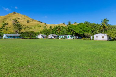 Typical houses in a small village in Viti Levu island, Fiji clipart