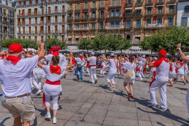 Pamplona, Spain: People celebrate San Fermin festival in traditional white abd red clothing with red necktie, Pamplona, Navarra, Spain.