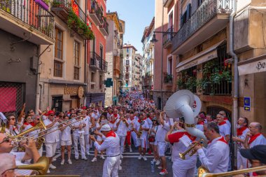 Pamplona, Spain: People celebrate San Fermin festival in traditional white abd red clothing with red necktie, Pamplona, Navarra, Spain.