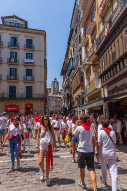 Pamplona, Spain: People celebrate San Fermin festival in traditional white abd red clothing with red necktie, Pamplona, Navarra, Spain.