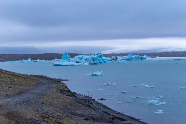 Güzel mavi buzdağları Jokulsarlon buzul gölüne yansıyor. Güney İzlanda. Vatnajokull Ulusal Parkı ve Vatnajokull Buzulu 'nun bir parçası, Avrupa' nın en büyük buzulu..