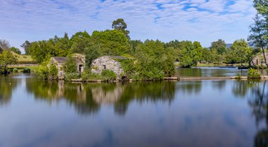 Long exposure at Azenhas de Adaufe, ancient water mills on the river, Braga, north of Portugal. clipart