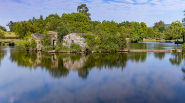 Long exposure at Azenhas de Adaufe, ancient water mills on the river, Braga, north of Portugal. clipart