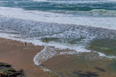 Sintra, Portugal: People at the beach of Ericeira, Mafra, Portugal clipart