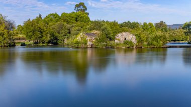 Long exposure at Azenhas de Adaufe, ancient water mills on the river, Braga, north of Portugal. clipart