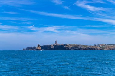 Lighthouse and cliffs of Carvoeiro cape in Peniche, Atlantic coast, Portugal clipart