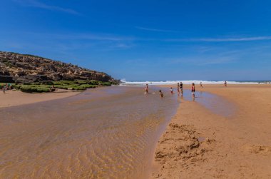 Sintra, Portugal: People at the beach of Foz do Lizandro, Ericeira, Portugal clipart