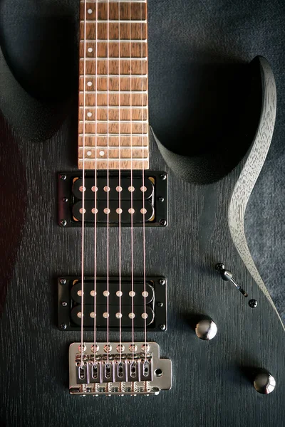 stock image close up black electric guitar on black background