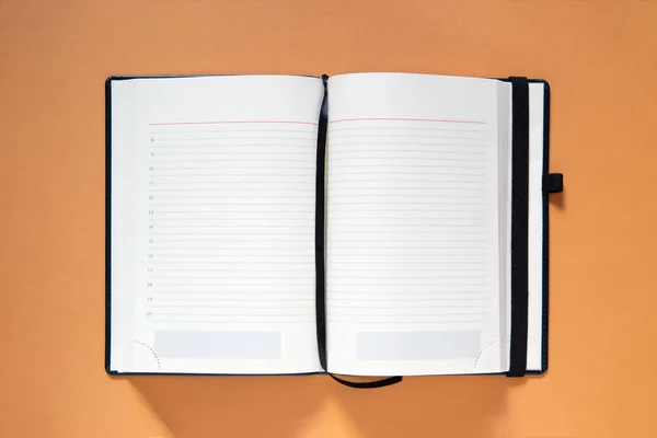 blank white open book on orange background