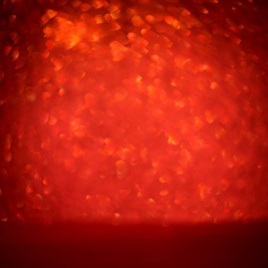 abstract red glitter texture background. macro of sparkling shiny heart shaped bokeh, defocused background, copy space, square