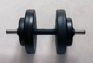 dumbbells  on a gray concrete floor in the gym. Fitness or bodybuilding concept. top view with lots of copy space